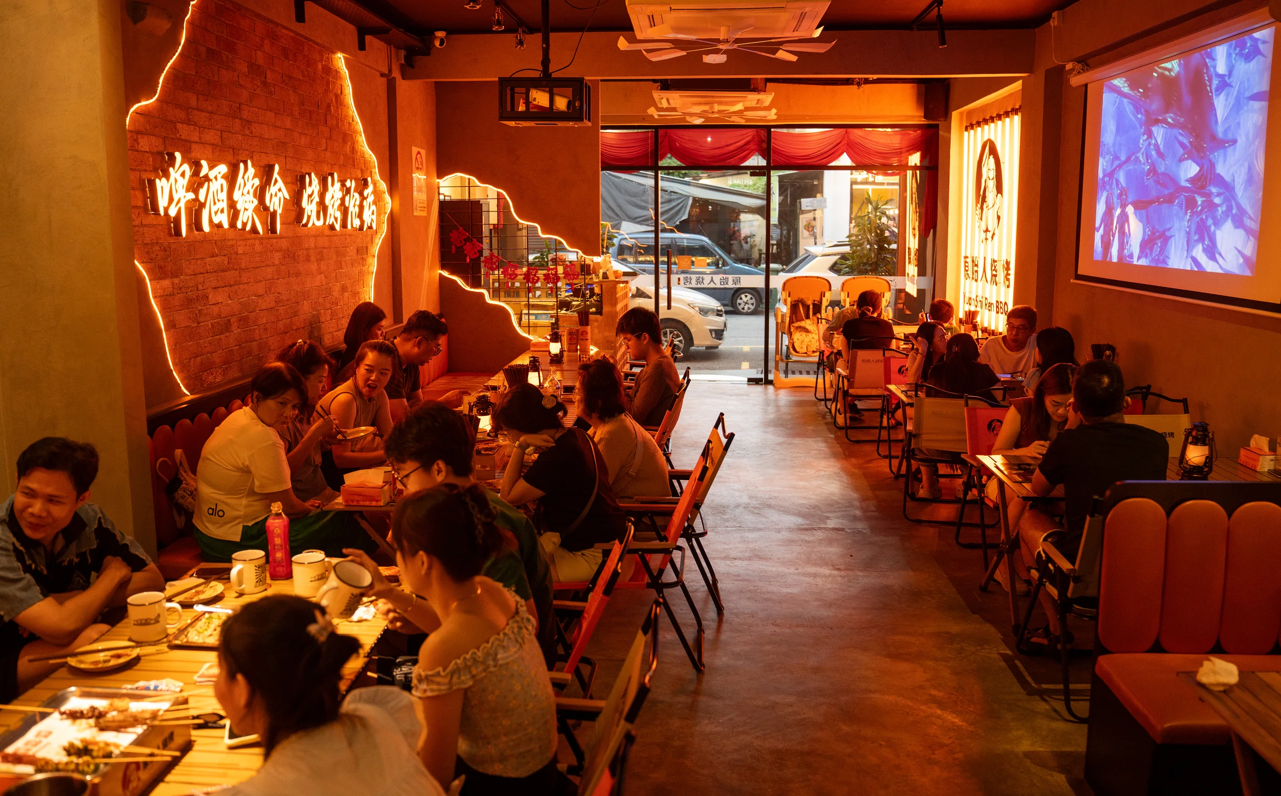 The George Town dining hall with its neon slogan wall and a full house