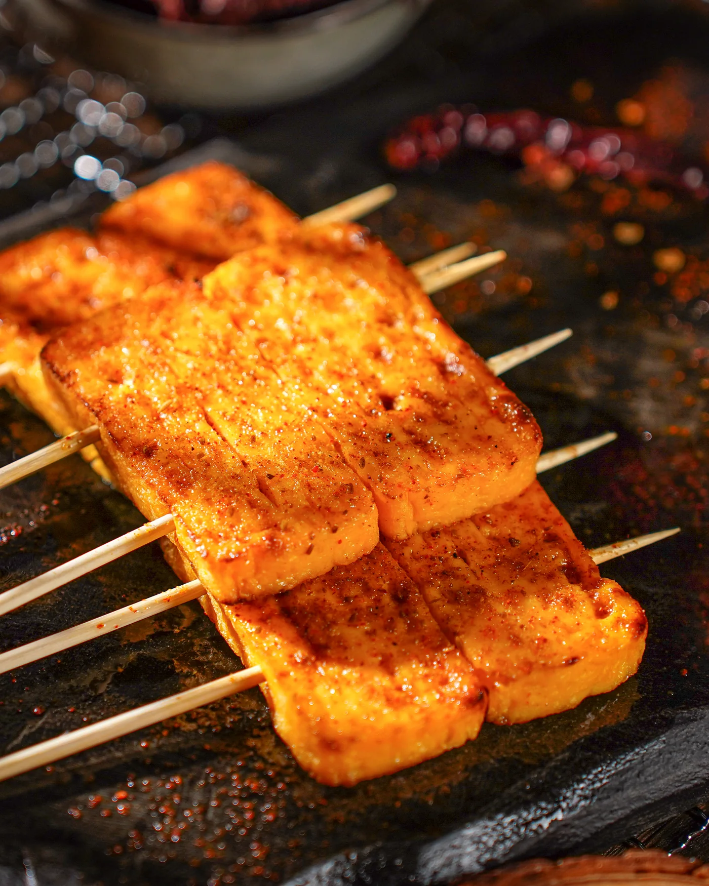 Grilled tamagoyaki skewers dusted with chilli
