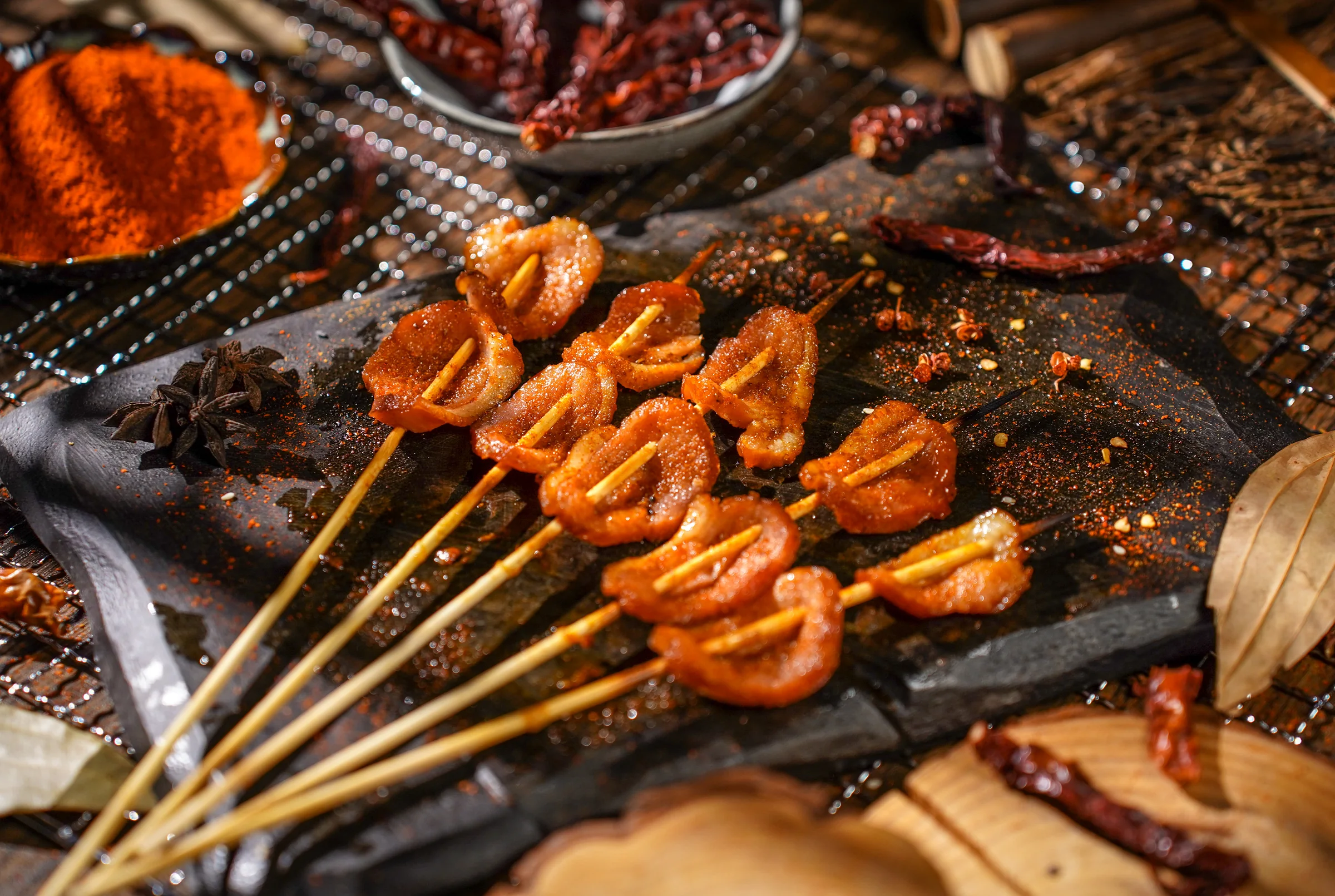 Smoked duck skewers on a slate
