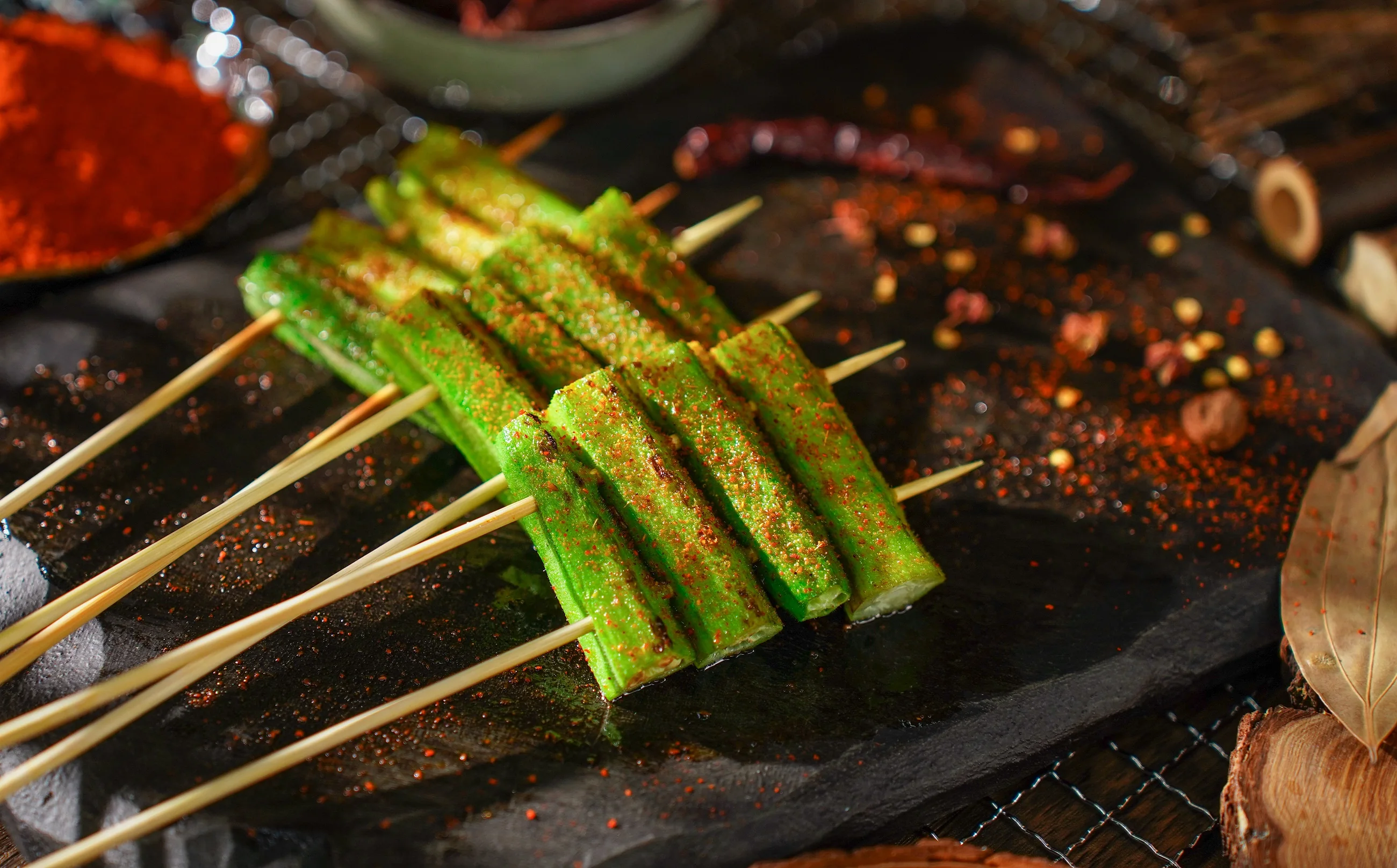 Lady's finger skewers dusted with chilli on a slate